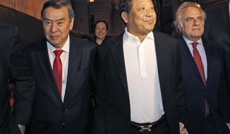 FILE - In this Oct. 26, 2015, file photo, Chinese billionaire Ng Lap Seng, center, leaves federal court with his attorney Benjamin Brafman, right, after he was released on bail in connection with a United Nations bribery scheme in New York. Prosecutor Douglas Zolkind said Thursday, June 29, 2017, during opening statements in Ng&#39;s trial that Ng corrupted two U.N. ambassadors so he could build a legacy by constructing a U.N. conference center in China. Defense attorney Tai Park countered in Manhattan federal court that Ng was a philanthropist who was betrayed by one of the ambassadors who demanded contributions from him. (AP Photo/Kathy Willens, File)