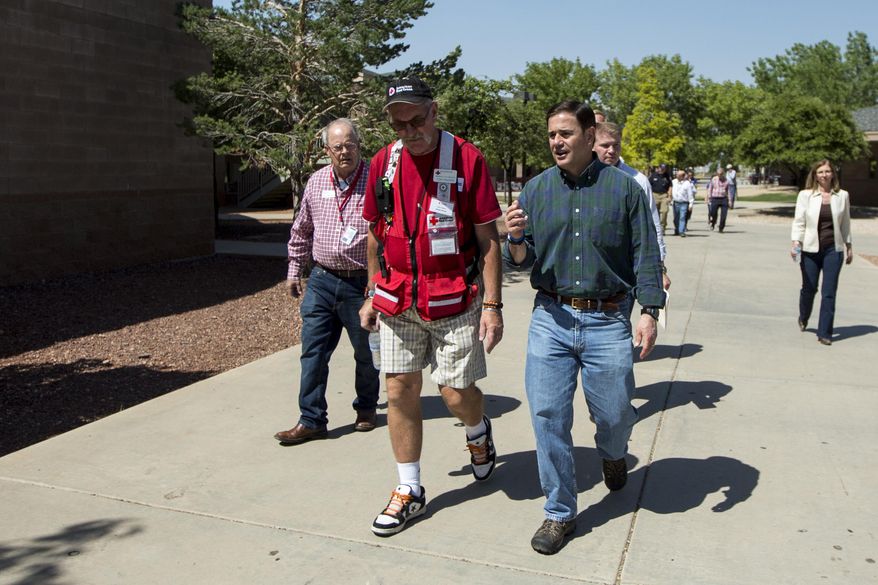 Arizona Gov. Doug Ducey tours the fire's evacuation center in Prescott Valley, Ariz., Thursday, June 29, 2017. Crews made considerable progress Thursday fighting an Arizona forest fire that shut down youth summer camps, forced thousands from their homes and came dangerously close to consuming a town. (AP Photo/Angie Wang)