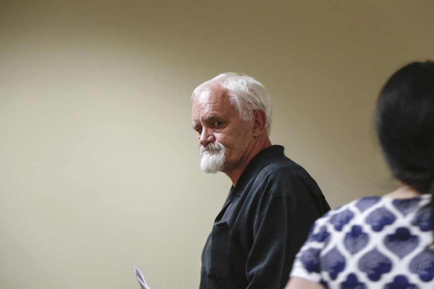 Clackamas County Judge Michael Wetzel sentenced former Clackamas County Sheriff's Det. Jeffrey Allen Green, center, to one year of probation Thursday, June 29, 2017. The former Oregon detective pleaded guilty to two misdemeanors for failing to investigate reports of child abuse, behavior his lawyer said was caused by burnout. Prosecutors say Green failed to thoroughly investigate dozens of reported crimes. (Stephanie Yao Long/The Oregonian via AP)