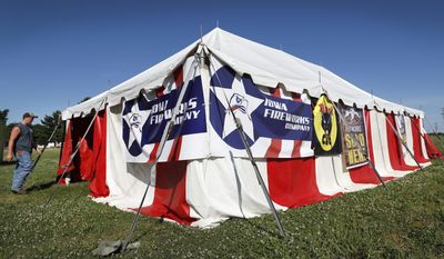 In this Friday, June 16, 2017 photo, customer Tyler Bandy, of Adel, Iowa, enters a tent owned by the Iowa Fireworks Company, in Adel, Iowa. Decades after a devastating fire caused by a dropped sparkler led Iowa to ban fireworks, the explosives are now legal in the state. But fireworks retailers and people eager to set off the explosives are finding that many local officials remain keenly aware of that fire so many years ago. (AP Photo/Charlie Neibergall)