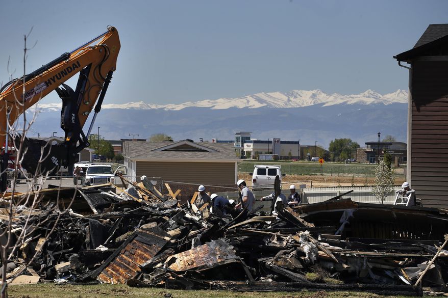 FILE - In this May 4, 2017, file photo, workers dismantle the charred remains of a house at the location where an unrefined petroleum industry gas line leak explosion killed two people inside their home in Firestone, Colo. Fire officials said that an investigation has revealed that the April 17, 2017 explosion was caused by unrefined natural gas that was leaking from a small abandoned pipeline from a nearby well. Energy companies are reporting they have nearly 129,000 underground oil and gas pipelines within 1,000 feet of occupied buildings in Colorado. Friday, June 30, 2017, is the deadline for companies to test those lines for leaks, and about 9,500 results were available at mid-day, with the vast majority indicating the pipelines passed the test.(AP Photo/Brennan Linsley, File)