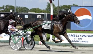 FILE - In this Aug. 5, 2006, file photo, Glidemaster, driven by John Campbell, wins the Hambletonian at Meadowlands Racetrack in East Rutherford, N.J. Campbell bids farewell to the Meadowlands, making his final drives at the track that helped the Hall of Famer become harness racing&#39;s career leader in purses. The 62-year-old Campbell is scheduled to drive in five races at the Meadowlands Racetrack on Friday night, June 30, 2017. (AP Photo/Bill Kostroun, File)