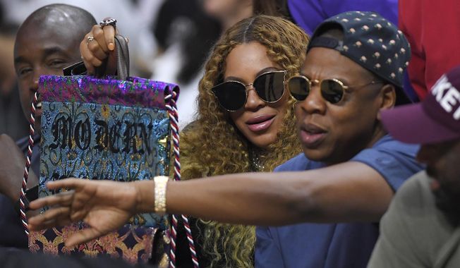 FILE - In this April 30, 2017, file photo, Beyonce and Jay Z watch during the first half in Game 7 of an NBA basketball first-round playoff series between the Los Angeles Clippers and the Utah Jazz in Los Angeles. Jay Z opened up about his relationship with Beyonce on his new album, "4:44," which was released June 30, 2017. (AP Photo/Mark J. Terrill, File)