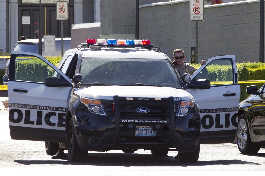 Las Vegas police investigate a shooting at a pain-management clinic in Las Vegas Thursday, June 29, 2017. A patient denied a same-day appointment at the clinic shot and injured two employees Thursday before fatally shooting himself, police said. (Richard Brian/Las Vegas Review-Journal via AP)