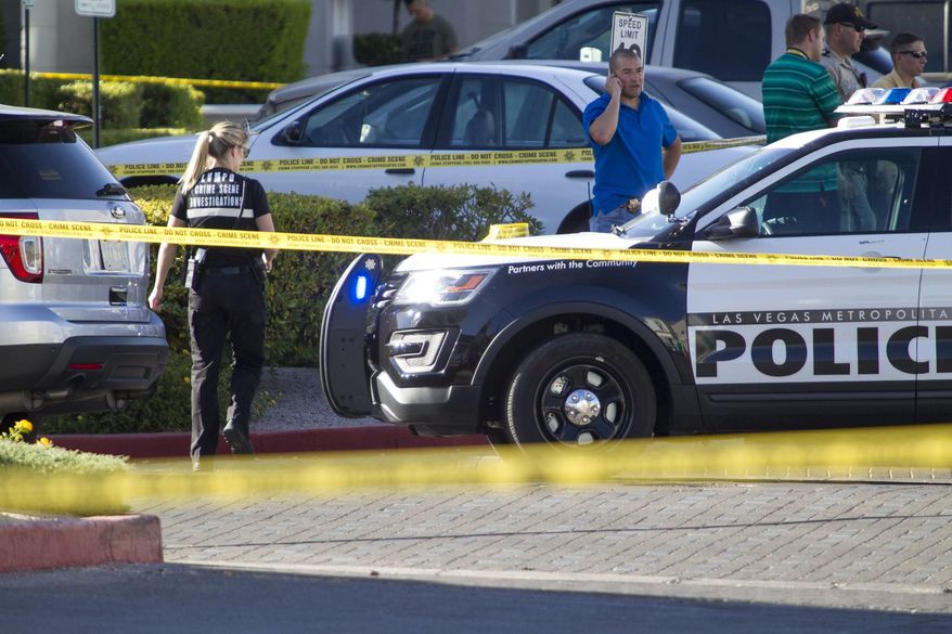 Las Vegas police investigate a shooting at a pain-management clinic in Las Vegas, Thursday, June 29, 2017. A patient denied a same-day appointment at the clinic shot and injured two employees Thursday before fatally shooting himself, police said. (Richard Brian/Las Vegas Review-Journal via AP)