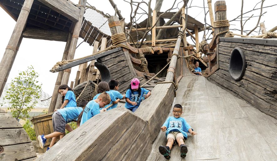 In this Thursday, June 29, 2017 photo, children explore an exhibit at the new Zoo Academy and Children's Adventure Trails at the Henry Doorly Zoo in Omaha, Neb. (Matt Miller/Omaha World-Herald via AP)