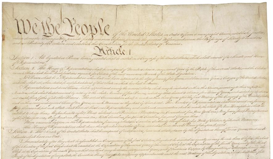 This photo made available by the U.S. National Archives shows the first page of the United States Constitution. (National Archives via AP)