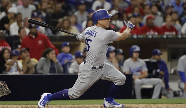 Los Angeles Dodgers&#x27; Austin Barnes watches his three-run home run during the sixth inning of the team&#x27;s baseball game against the San Diego Padres on Friday, June 30, 2017, in San Diego. (AP Photo/Gregory Bull)