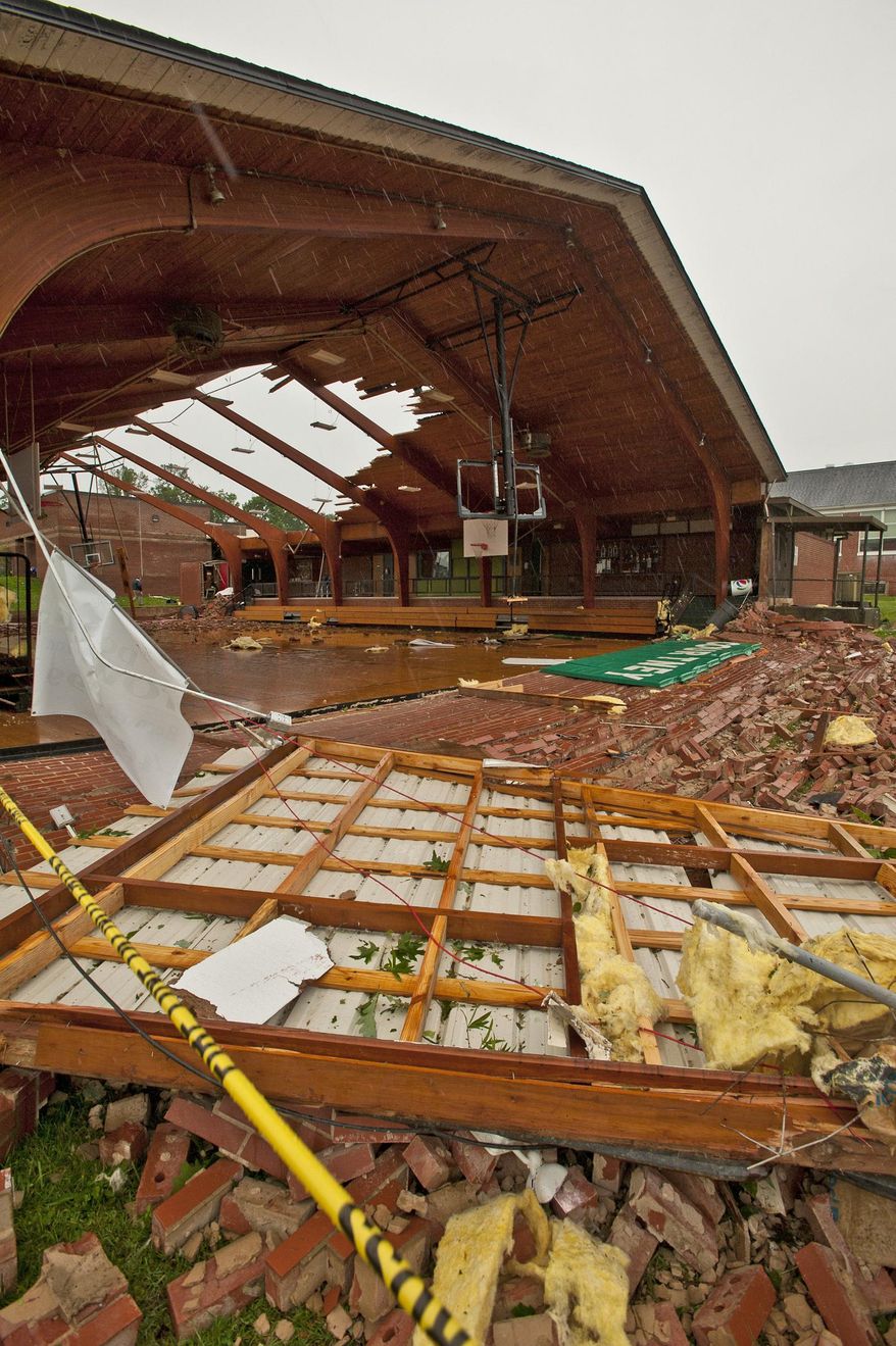 In this May 24, 2017 photo, the roof was blown off gymnasium at Courtney Elementary School and the end walls were blown in by a tornado that passed through the area in Courtney, N.C. Beyond an architectural treasure, the gym was something of a community hub for Courtney, a place that was open to locals outside of school hours for birthday parties and recreation-league sports. (Walt Unks/The Winston-Salem Journal via AP)