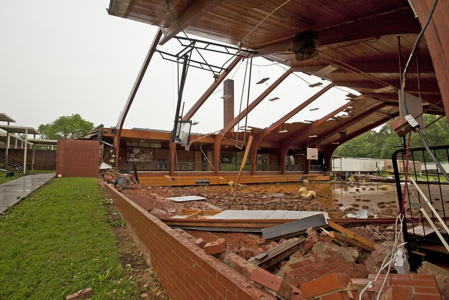 In this May 24, 2017 photo, the roof was blown off gymnasium at Courtney Elementary School and the end walls were blown in by a tornado that passed through the area in Courtney, N.C. Beyond an architectural treasure, the gym was something of a community hub for Courtney, a place that was open to locals outside of school hours for birthday parties and recreation-league sports. (Walt Unks/The Winston-Salem Journal via AP)