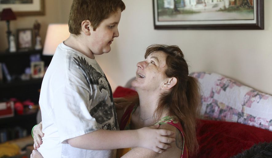 In this May 18, 2017, photo, Karen Goodwin greets her autistic son Connor McConnaughy, 10, as he comes home from school in Deerfield, Ohio. Adam Shay died too young of a heroin overdose at age 21. But his thoughtfulness to have checked the box as an organ donor on his driver’s license led to gifts of life for two Ohio women. Goodwin received one of Adam’s kidneys. (Lisa DeJong/The Plain Dealer via AP)