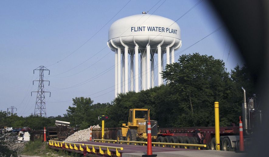 ADVANCE FOR USE SUNDAY, JULY 2 - FILE - In this June 14, 2017, file photo, the Flint Water Plant tower is seen in Flint, Mich. The state's legal bills continue to mount in Flint's man-made water crisis and costs are only expected to balloon as Attorney General Bill Schuette's outside team of investigators turns toward prosecuting a dozen current or former state employees or appointees whose criminal defenses are being covered by taxpayers. (Shannon Millard/The Flint Journal-MLive.com via AP, File)