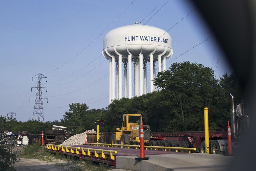 ADVANCE FOR USE SUNDAY, JULY 2 - FILE - In this June 14, 2017, file photo, the Flint Water Plant tower is seen in Flint, Mich. The state&#39;s legal bills continue to mount in Flint&#39;s man-made water crisis and costs are only expected to balloon as Attorney General Bill Schuette&#39;s outside team of investigators turns toward prosecuting a dozen current or former state employees or appointees whose criminal defenses are being covered by taxpayers. (Shannon Millard/The Flint Journal-MLive.com via AP, File)