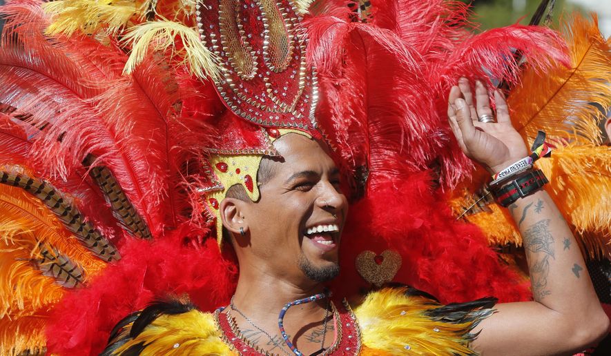 A participant smiles during the Gay Pride demonstration and parade, the climax of the 10-day WorldPride festivities, in Madrid, Spain, Saturday, July 1, 2017. Madrid is celebrating WorldPride 2017, a colorful mixture of vindication for sexual and gender diversity and all-night partying. (AP Photo/Paul White)
