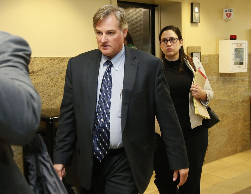 In this Friday, June 30, 2017 photo, Shannon Kepler, left, arrives with his legal team for afternoon testimony in his trial in Tulsa, Okla. Kepler, a former Oklahoma police officer who fatally shot his daughter's black boyfriend in 2014 is on trial for the third time after jurors in previous trials couldn't decide whether or not to convict him of first-degree murder. (AP Photo/Sue Ogrocki)