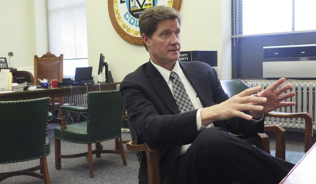In this May 19, 2017, file photo, Milwaukee County District Attorney John Chisholm talks in his office about the benefits of placing prosecutors with police officers in neighborhoods to address crime and seek alternatives to prison. (AP Photo/Ivan Moreno) ** FILE **