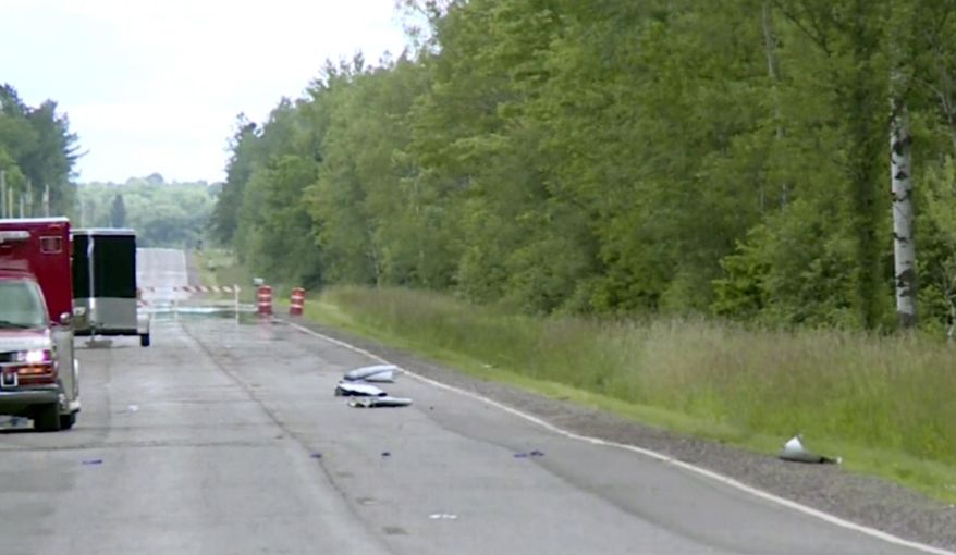 In this image made from a video provided by WAOW debris covers the road on Sunday, July, 2, 2017, near Phillips, Wis., after several people were killed in an airplane crash on Saturday. The Price County Sheriff's Office says the plane had left from Chicago and was heading to Canada on a fishing trip. (Courtesy WAOW via AP)