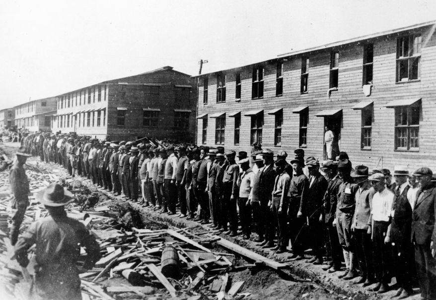 Members of the first contingent of New Yorkers drafted into the United States Army are shown lined up in front of their barracks at Camp Upton, Yaphank, Long Island, N.Y., as America enters World War I in 1917.  The U.S. Army recruited more than 4,000,000 men for World War service.  (AP Photo)