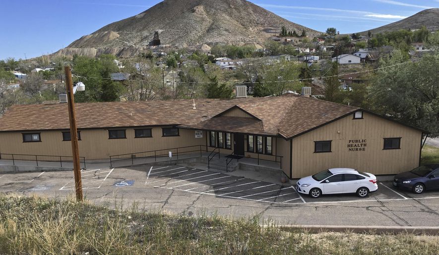 FILE - In this May 21, 2017, file photo, cars are parked outside a Community Health Nursing clinic in Tonopah, Nev. Nevada Gov. Brian Sandoval plans to begin requiring state agency administrators to voluntarily disclose all federal reviews after he and his staff were surprised to first learn in a report by The Associated Press of a critical assessment of the state's rural public health clinics. The U.S. Department of Health and Human Services found misused grant funds, sloppy record-keeping and undertrained staff at state-run reproductive health clinics in 2015.(AP Photo/Alison Noon,File)