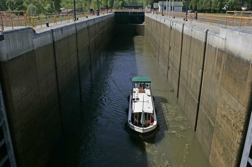 FILE - In this May 13, 2008 file photo, a canal boat goes through Lock 2 of the Erie Canal in Waterford, N.Y. Ground was broken for the Erie Canal 200 years ago, and when the 363-mile canal fully opened in 1825, it was the greatest engineering feat of the era and one that would change history. (AP Photo/Mike Groll, File)