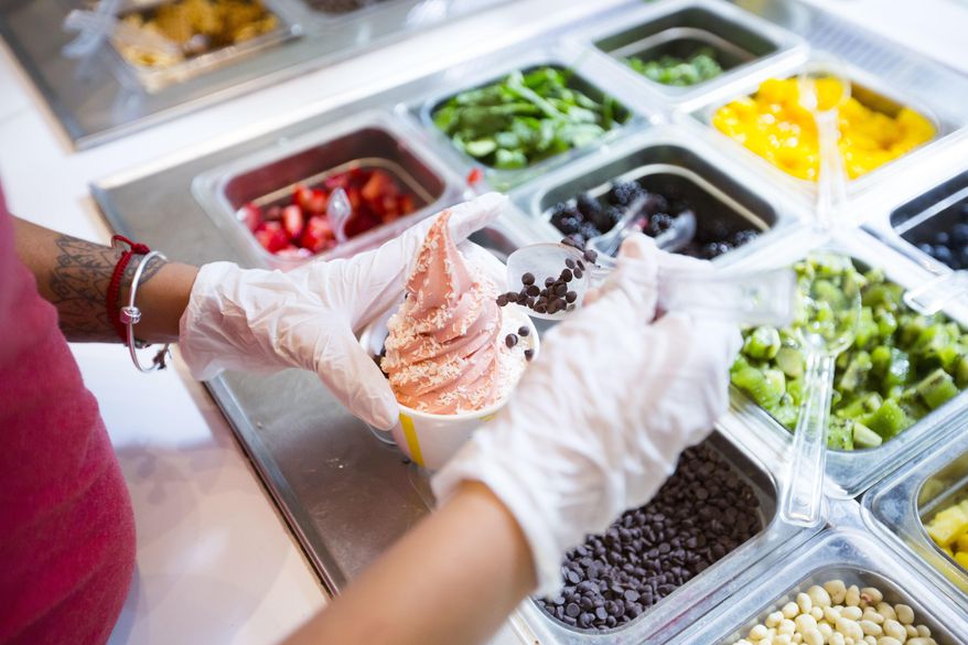 In this June 20, 2017 photo, a cup of strawberry vegan soft serve is prepared at Chloe's Soft Serve Fruit Co., in New York. A new generation of dairy-free vegan ice cream varieties features creamier bases and more interesting flavors that appeal to vegans, vegetarians and meat eaters alike. (AP Photo/Michael Noble Jr.)