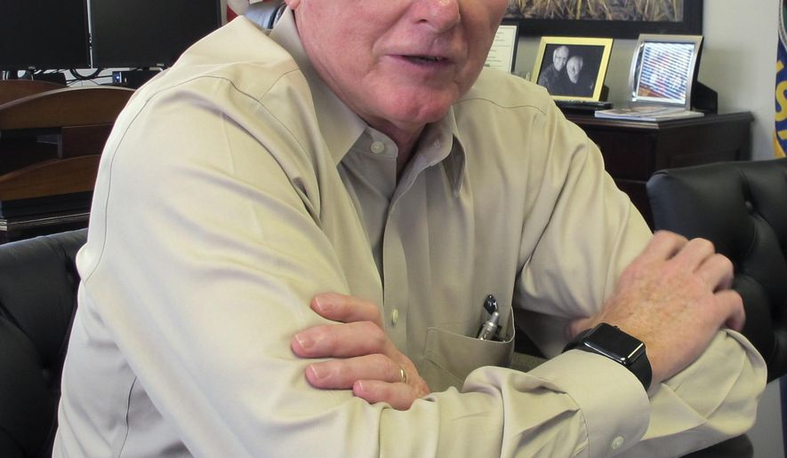 In this June 28, 2017, photo, Kansas Revenue Secretary Sam Williams answers questions about tax issues during an interview in his Topeka, Kan., office. The Department of Revenue reports that the state collected $72 million more than expected in taxes in June. (AP Photo/John Hanna)