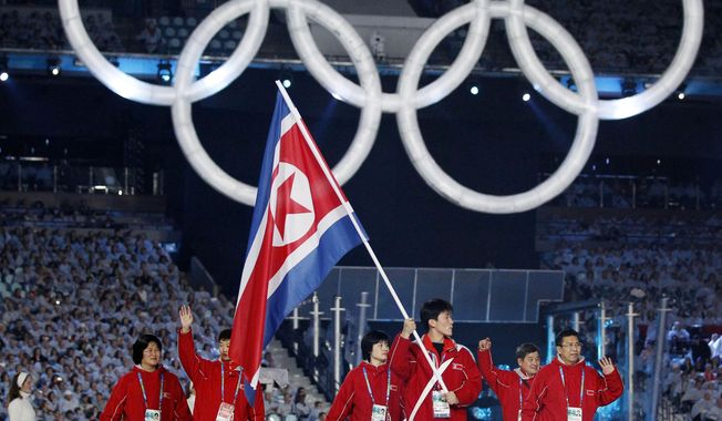 FILE - In this Feb 12, 2010 file photo, North Korea&#x27;s Song Chol Ri carries the flag during the opening ceremony for the Vancouver 2010 Olympics in Vancouver, Canada. Seven months ahead of the Pyeongchang Olympics, many in South Korea, including new liberal President Moon Jae-in, hope to use the Games as a venue to promote peace with rival North Korea. To do so, the North’s participation is essential, but an ongoing nuclear tension and a lack of winter sports athletes in North Korea could ruin the attempts at reconciliation. (AP Photo/Mark Baker, File)
