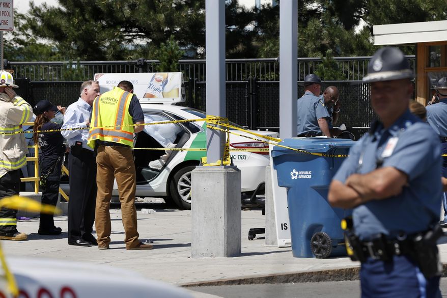 Emergency personnel work at the scene where a taxi driver struck a group of pedestrians, injuring several, Monday, July 3, 2017, in Boston. A police official said the crash is believed to be a case of "operator error" in which the driver stepped on the gas pedal instead of the brake. (AP Photo/Michael Dwyer)