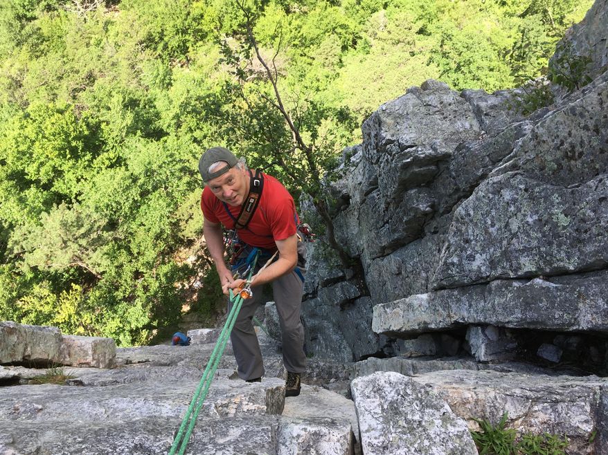 In this June 25, 2017 photo climber Phil Brown rappels down from Old Man's Route on the west face of Seneca Rocks in West Virginia. The crag has no hiking trail to the top so you have to either rappel or climb down. (AP Photo/Michael Virtanen)