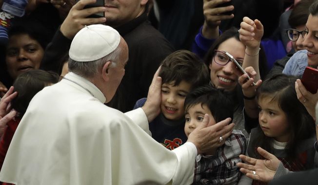 FILE - In this Thursday, Dec. 15, 2016 file photo, Pope Francis greets children from the Vatican&#x27;s Bambino Gesu Pediatric Hospital. During the audience in the Vatican&#x27;s Paul VI hall, Francis exhorted hospital caregivers not to fall prey to corruption, which he called the “greatest cancer” that can strike a hospital. “Bambino Gesu has had a history that hasn&#x27;t always been good,” the pope said, jettisoning his prepared remarks to decry the temptation to “transform a good thing like a children&#x27;s hospital into a business, and make a business where doctors become businessmen and nurses become businessmen, everyone&#x27;s a businessman!” (AP Photo/Alessandra Tarantino)