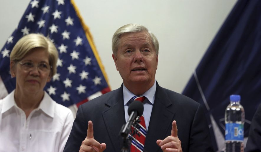 U.S. Sen. Lindsey Graham right, speaks during a press conference at the Resolute Support headquarters in Kabul, Afghanistan, Tuesday, July 4, 2017. Sen. Elizabeth Warren is seen left. (AP Photo/Rahmat Gul) ** FILE **
