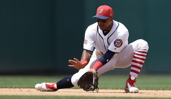 Washington Nationals shortstop Wilmer Difo (1) fields a ball during a baseball game against the New York Mets, Tuesday, July 4, 2017, in Washington. The Nationals won 11-4. (AP Photo/Nick Wass)