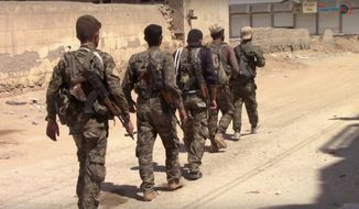 This frame grab from video released Tuesday, July 4, 2017, and provided by Furat FM, a Syrian Kurdish activist-run media group, shows U.S.-backed Syrian Democratic Forces (SDF) fighters in the eastern side of Raqqa, Syria. The SDF forces have breached the wall around Raqqa&#39;s Old City, the U.S. military said Tuesday, marking a major advance in the weeks-old battle to drive Islamic State militants out of their self-declared capital. (Furat FM, via AP)