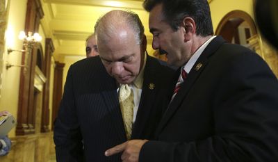 New Jersey Senate President Steve Sweeney, left, D-West Deptford, listens to New Jersey Democratic Assembly Speaker Vincent Prieto, right, D-Secaucus, as they talk in a hallway at the Statehouse before announcing an agreement to end the New Jersey budget impasse Monday, July 3, 2017, in Trenton, N.J. (AP Photo/Mel Evans)