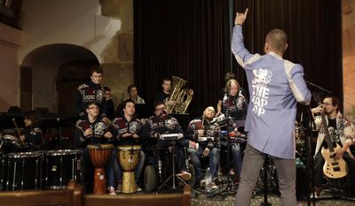 n this picture taken on Thursday, Feb. 23, 2017, members of the Tap Tap orchestra perform during a charity concert in Prague Czech Republic. What was created some 18 years ago in efforts to give kids some extracurricular activity at a renowned school for the disabled in Prague has become a major music act that has drawn millions of listeners and fans, first at home and gradually abroad. (AP Photo/Petr David Josek)