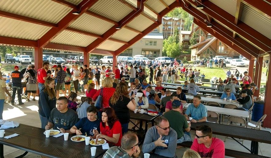 In a photo provided by Bret Howser, people attend a pancake breakfast in Brian Head, Utah on Tuesday, July 4, 2017, that volunteers and residents put on for local firefighters who've been fighting a wildfire that forced the evacuation of the town for nearly two weeks. (Bret Howser via AP)