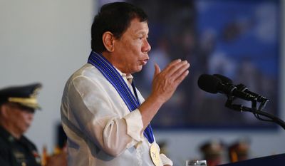 Philippine President Rodrigo Duterte addresses troops during the 70th anniversary celebration of the Philippine Air Force at Clark Freeport Zone Tuesday, July 4, 2017 in Pampanga province, north of Manila, Philippines. The Philippines&#39; top court on Tuesday upheld President Duterte&#39;s martial law declaration in the southern third of the country, dismissing petitions to nullify it.(AP Photo/Bullit Marquez)