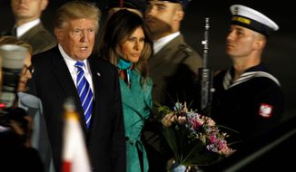 LED IN: President Trump, right and the first lady Melania Trump walk past the honor guards as they arrive to Warsaw, Poland, Wednesday, July 5, 2017. President Donald Trump is back to Europe hoping to receive a friendly welcome in Poland despite lingering skepticism across the continent over his commitment to NATO, his past praise of Russian President Vladimir Putin and his decision to pull the U.S. out of a major climate agreement. (AP Photo/Czarek Sokolowski) (Associated Press)