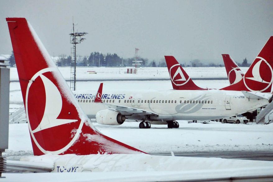 FILE- In this Jan. 10, 2017 file photo, Turkish Airlines aircrafts are stationed at Ataturk International Airport covered in snow, in Istanbul, Tuesday. Istanbul-based Turkish Airlines tweeted early Wednesday that it had been exempted from a ban on laptops in airplane cabins. (Faik Kaptan/Depo Photos via AP, File)