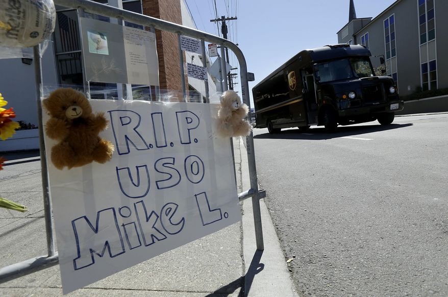FILE - In this Jute 16, 2017, file photo, a UPS truck drives toward a sign for Mike Lefiti, one of the UPS drivers slain, at a memorial set up outside of a UPS facility in San Francisco. A union official says only five of the 40 San Francisco UPS workers have returned to work after witnessing the fatal shootings of three colleagues last month. (AP Photo/Jeff Chiu, file)