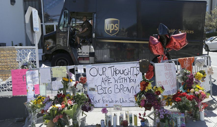 FILE - In this June 16, 2017 file photo, a UPS truck is driven past a memorial set up outside of a UPS facility in San Francisco. A union official says only five of the 40 San Francisco UPS workers have returned to work after witnessing the fatal shootings of three colleagues last month. (AP Photo/Jeff Chiu, file)