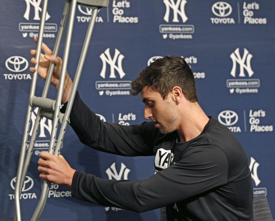 New York Yankees outfielder Dustin Fowler carefully places his crutches behind him before speaking to the media during a brief press conference at Yankee Stadium in New York, Wednesday, July 5, 2017. Fowler ruptured his right patellar tendon last Thursday after crashing into the outfield wall in the first inning of his major league debut in Chicago.  (AP Photo/Kathy Willens)