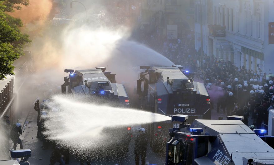 The Police uses water canons during a protest against the G-20 summit in Hamburg, northern Germany, Thursday, July 6, 2017. The leaders of the group of 20 meet July 7 and 8. (AP Photo/Michael Probst)