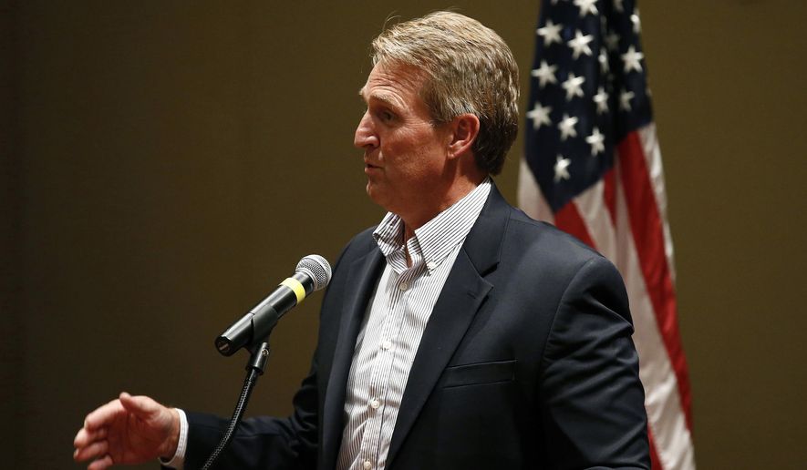 FILE - In this May 30, 2017, file photo, Sen. Jeff Flake, R-Ariz., speaks to members of the Glendale Chamber of Commerce in Glendale, Ariz. Protests against a health care bill in the U.S. Senate heated up Thursday, July 6, when seven opponents of the plan were arrested at Flake's Phoenix and Tucson offices. The protesters were taken into custody as they were trying to sway the Republican's vote on the stalled bill repealing much of former President Barack Obama's health overhaul. (AP Photo/Ross D. Franklin, File)