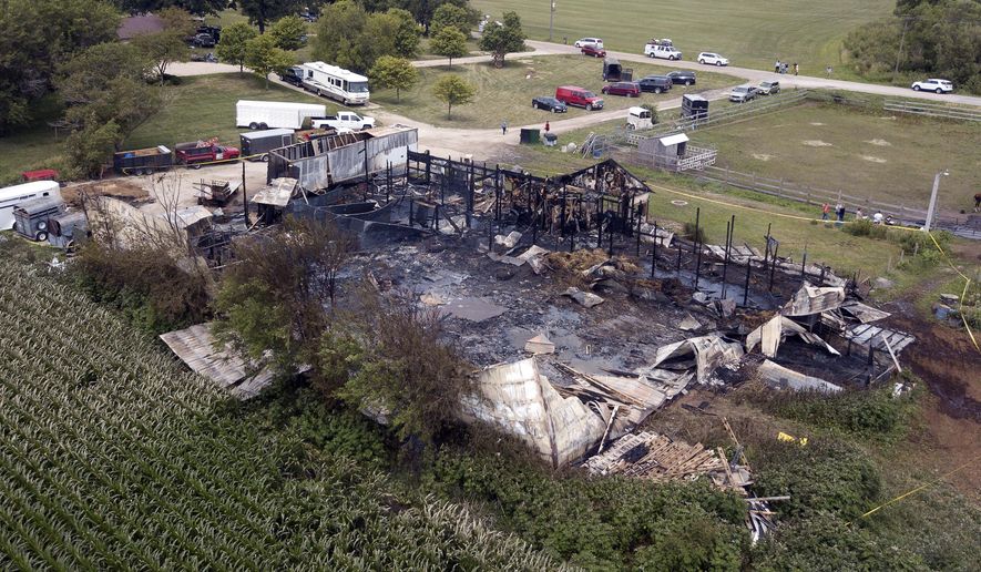 This Wednesday, July 5, 2017 photo shows the site where 18 horses died after a barn fire in Plainfield, Ill. Authorities say the horses died and two people were hurt after a morning blaze struck a horse-boarding barn in the southwestern Chicago suburbs. Plainfield Deputy Fire Chief Jon Stratton says 30 horses were in the barn when the fire started but a dozen survived because owners and firefighters were able to let them out. The cause of the blaze is under investigation. (Mark Welsh/Daily Herald via AP)