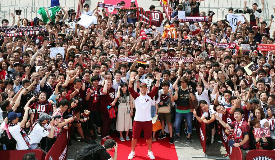 Germany&#39;s Lukas Podolski, front center, poses for photos with fans during a welcoming ceremony in Kobe, western Japan Thursday, July 6, 2017. Podolski will play for Japanese club Vissel Kobe. (Tsuyoshi Ueda/Kyodo News via AP)