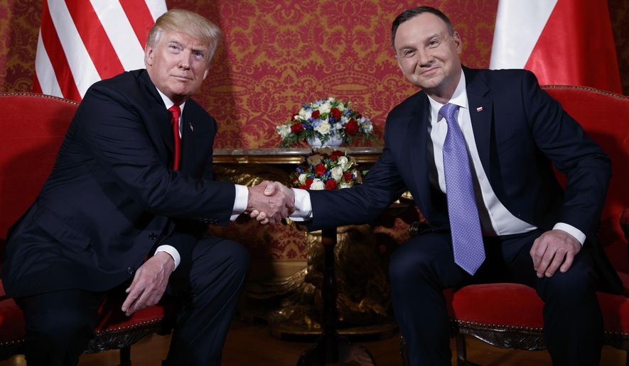 U.S. President Donald Trump, left, and Polish President Andrzej Duda pose for photographers as they shake hands during their meeting at the Royal Castle, Thursday, July 6, 2017, in Warsaw. (AP Photo/Evan Vucci)