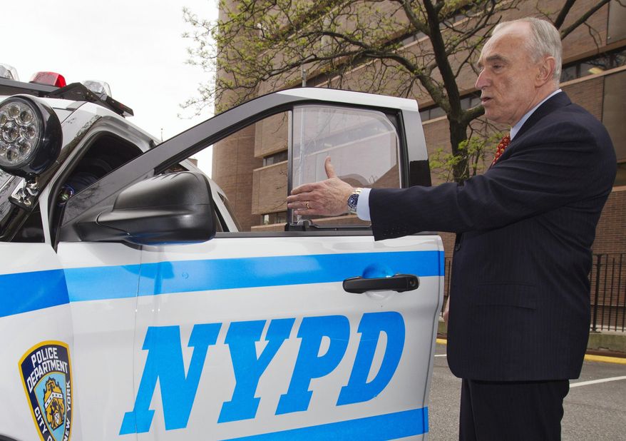 In this May 10, 2016, photo, New York Police Commissioner William Bratton displays new bullet resistant windows and door panels during a news conference in New York. After two officers were fatally gunned down through the window of their squad car in 2014, the city embarked on plan to outfit all of its squad cars with inch-thick bullet-resistant glass and armored door panels. That plan did not cover RV-like mobile command posts, like the one Officer Miosotis Familia sat inside when she was fatally shot while on duty in the early hours of Wednesday, June 5, 2017. (Chad Rachman/The New York Post via AP)