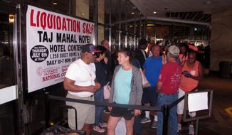 Gerald Winchester, left, chats with Marie Marine, right, as they wait to enter the former Trump Taj Mahal casino in Atlantic City N.J. on Thursday July 6, 2017 for a sale of the casino hotel&#39;s contents. Included in the items for sale were crystal chandeliers from Austria that now-President Donald Trump bought for the casino when he opened it in 1990. The casino shut down last year under different ownership. (AP Photo/Wayne Parry)