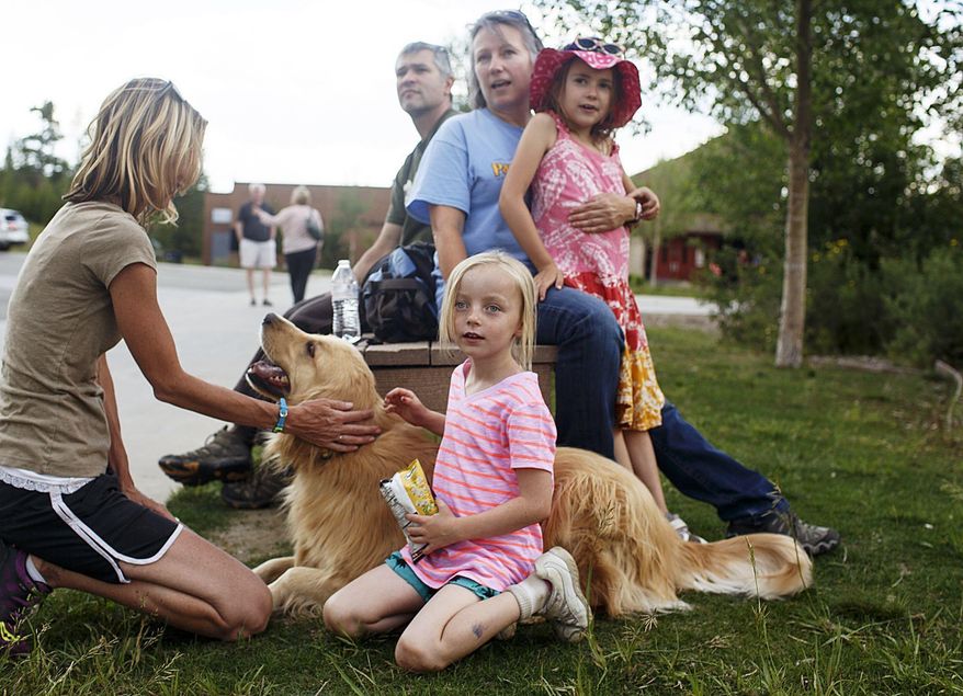 Paige Ratliff, 7, front, and the evacuees watch from Summit Middle School in Frisco, Colo., as a wildfire continues near their homes close to Peak 2 on Wednesday, July 5, 2017. A wildfire forced the evacuation of hundreds of homes about a mile north of Colorado’s Breckenridge Ski Resort on Wednesday. (Hugh Carey/Summit Daily News via AP)